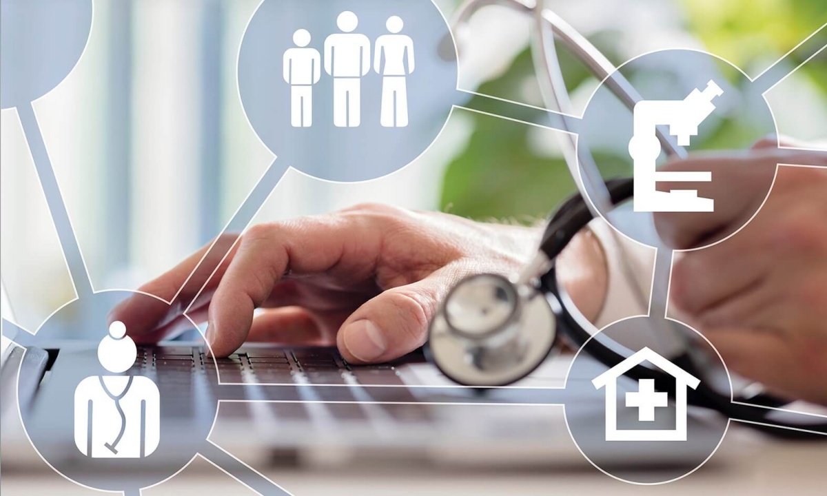 Medical Informatics Hand of a person with a stethoscope typing on a laptop keyboard, surrounded by medical icons such as doctor, microscope, hospital, and people symbols.